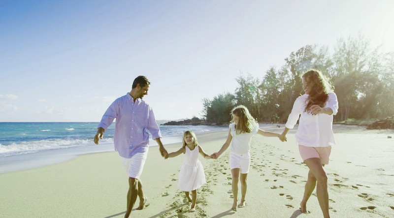Happy young family enjoying on beach