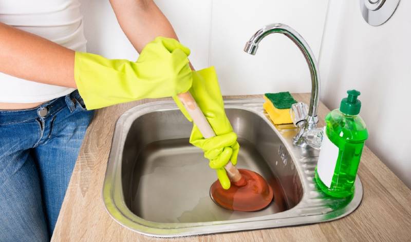 Woman in yellow glops inside the kitchen