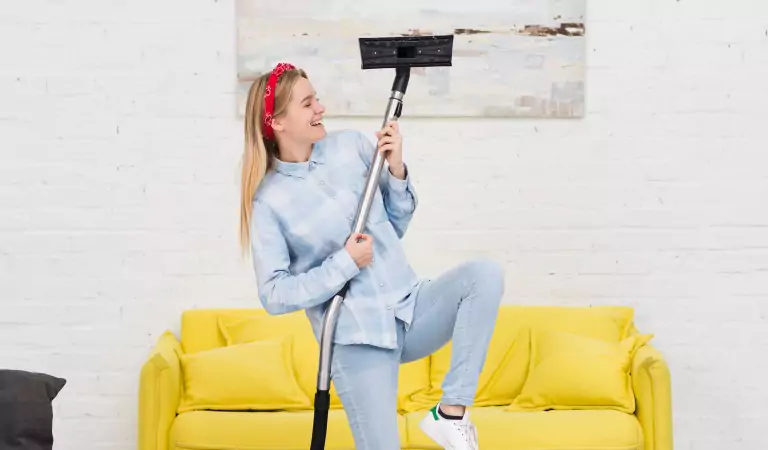 young woman with a vacuum cleaner