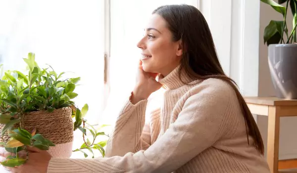woman with her indoor plants inside of her house