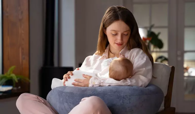 young mother with her newborn baby inside of a house