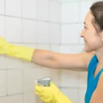 woman cleaning bathroom tiles
