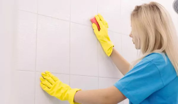 woman cleaning tile grout
