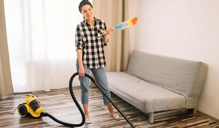 woman with some cleaning supplies ready to clean