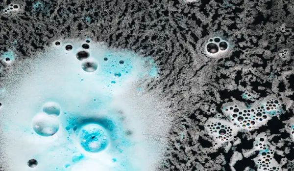 Blob of bright blue foam on carpet