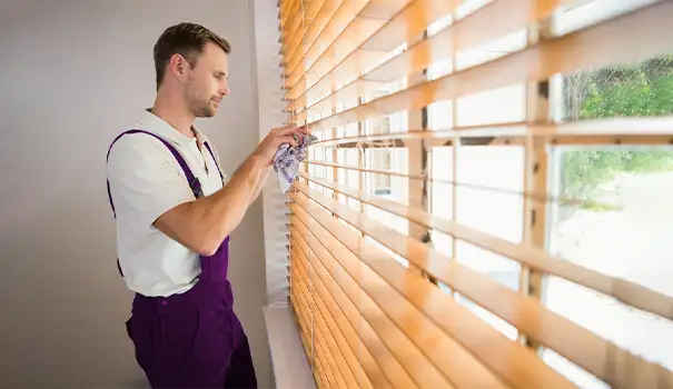 Man Cleaning House Window