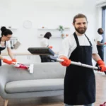 Portrait of bearded cleaner from cleaning service holding vacuum cleaner