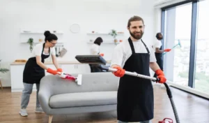 Portrait of bearded cleaner from cleaning service holding vacuum cleaner