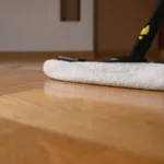 Washing mop on the parquet, close up.