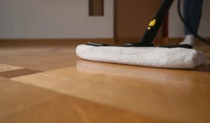 Washing mop on the parquet, close up.