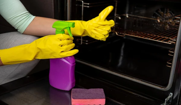 Clean your oven safely using appropriate products while wearing gloves for hygiene